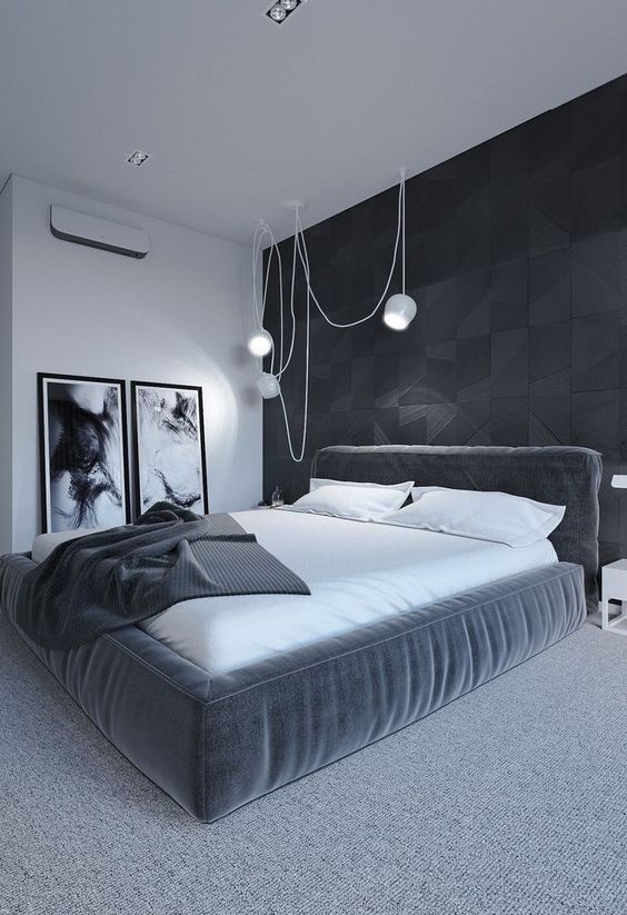 Imagine sleeping in this minimalist black, white, & gray bedroom. The bed looks super cozy w/ its white sheets & soft headboard. What a relaxing room!