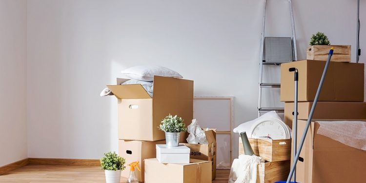 Move. Cardboard boxes and cleaning things for moving into a new home